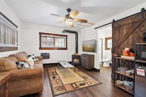 This bright and airy living room with large windows that let in natural light and nature views, the perfect spot for family time.