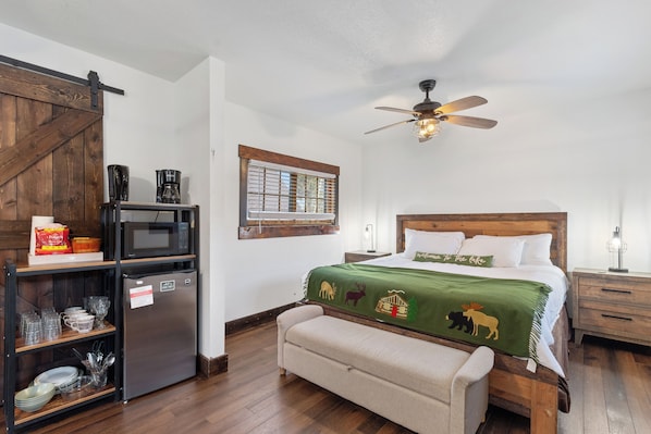 Wake up refreshed in this beautiful bedroom with large windows showcasing the stunning outdoors.