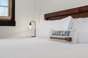 Sleep peacefully in this cozy bedroom with mountain views and soft, luxurious bedding.