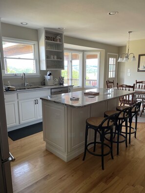 Island, kitchen, bay window, deck and dining area.