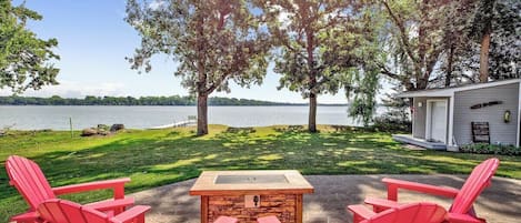 Private patio looking out at the lake between the two oak trees! 

We have 4 Adirondack Chairs around a propane fire table.  

Lake-shore and dock access are included.  (shore is rocky, rocks can get slippery).  Dock includes a swimming ladder. 