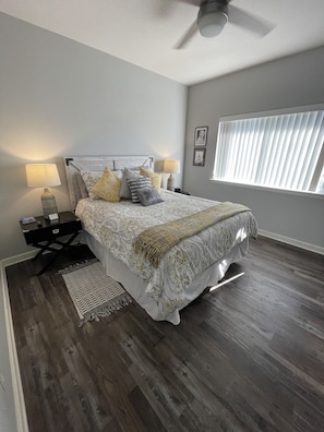 Second bedroom in main house with a queen bed and private work space 