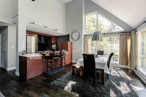 spacious dining room and kitchen with windows all around for views