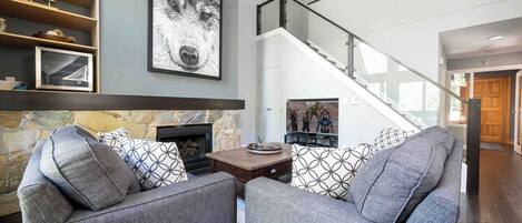 living room with new gas fireplace and 2nd story bedroom up the stairs