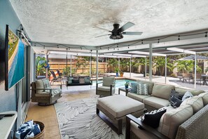 Super cozy space off the pool area. Comfy sectiontal and chairs w/ a smart tv on the wall.