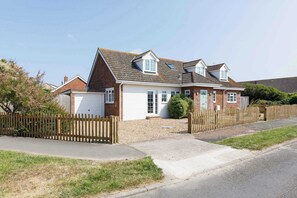 The exterior of the home, with ample driveway parking.