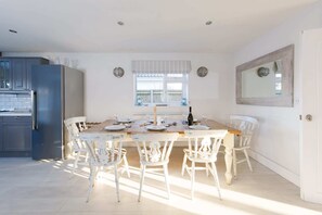 The dining table seats up to 8 guests and within arms reach of the kitchen.