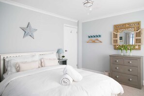 The bedrooms are beautifully decorated and furnished in cool greys and blues.