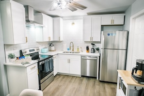 This fully updated kitchen boasts brand-new stainless steel appliances and is thoughtfully stocked with everything you need to effortlessly create a delicious meal.