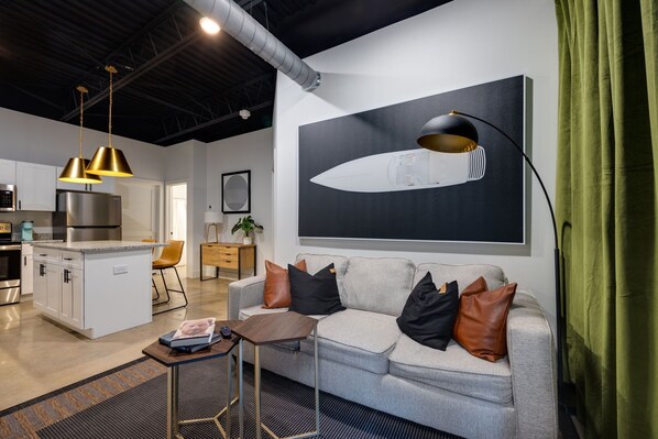 Prepare to be impressed by the seamless blend of comfort and elegance in this apartment's spacious living area, complete with a well-equipped kitchen.