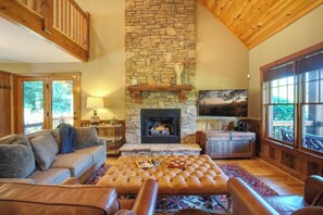 The living room has a vaulted ceiling and gas log fireplace