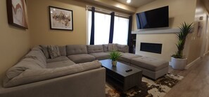 The spacious living area features a fireplace andTV for a great movie night or relaxing in front of the fire.