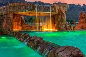 Sage Creek at sunset - red rock waterfall splashing into the pool
