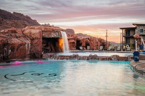 Sage Creek at sunset - red rock waterfall splashing into the pool