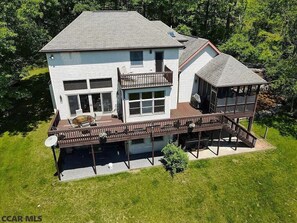 Large back deck, covered screened in porch and second floor balcony off the upstairs owners suite