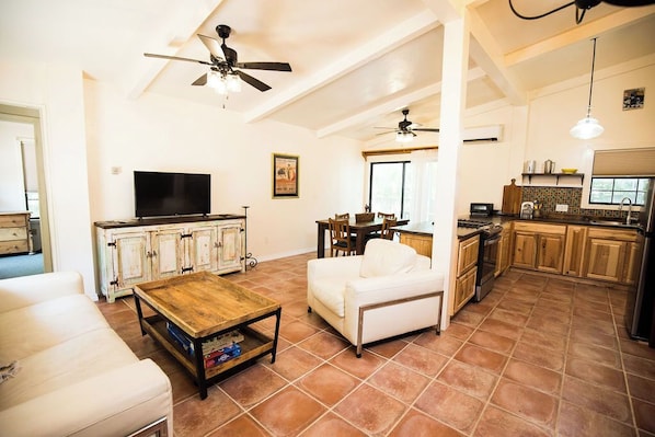 Beautiful open-spaced living and kitchen area with adorable Spanish touches.