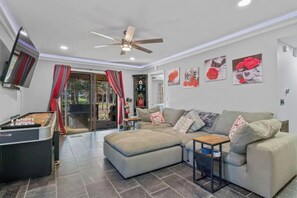 Spacious living room.  Watch TV, play foosball or shuffleboard, while relaxing. 