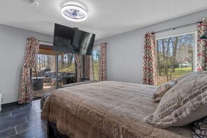 Master bedroom with TV from the ceiling and private access to the patio. 