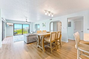 Open-concept dining area with natural light and ocean views.