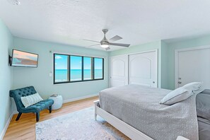 Elegant master bedroom with a queen-size bed and serene coastal decor.