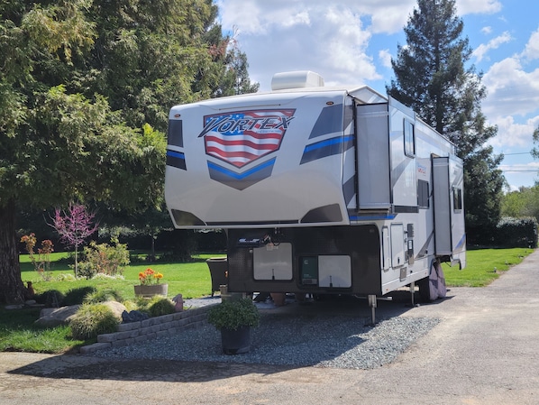 2022 Genisis Vortex Toy Hauler on 1/2 acre enclosed front yard.