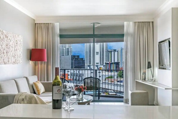 Open-plan living in the one bedroom apartment allows for a comfortable dining area with views out to Darwin CBD