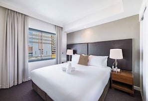 Fall asleep in the comforts of a king-size bed with nightstands and curtains for uninterrupted nights.