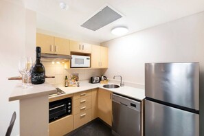 A fully-equipped kitchen comes with a full-sized fridge, electric stovetop, dishwasher and a microwave.