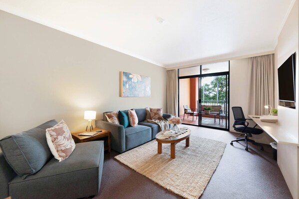 Modern decor features wooden tables and sleek neutral furnishings complemented with fun pops of red decor. There's a roll away bed that can sleep one child upon request.