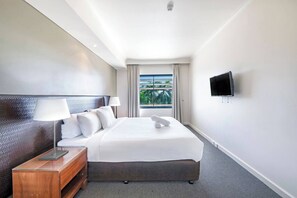 In the bedroom, there is a plush king-sized bed topped with premium, hotel-style linens. There is a TV directly viewable from bed, perfect for cosy nights in.