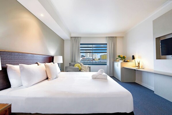 A light-filled room is complemented by a large window showcasing views of Darwin city and its surroundings.