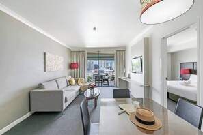 The spacious one bedroom apartment has a private balcony and sun-soaked living room with a TV and Wi-Fi 