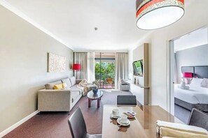Relax in the living room. It’s fitted with generous sofa seating with TV, a dedicated workspace and dining table set for four.