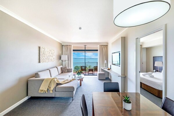 [Apt 1] The spacious one-bedroom apartment has a private balcony and sun-soaked living room with a TV and Wi-Fi 