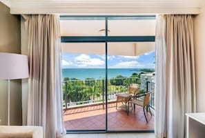 Sliding glass doors reveal a large undercover balcony where you can enjoy your morning coffee with a view.