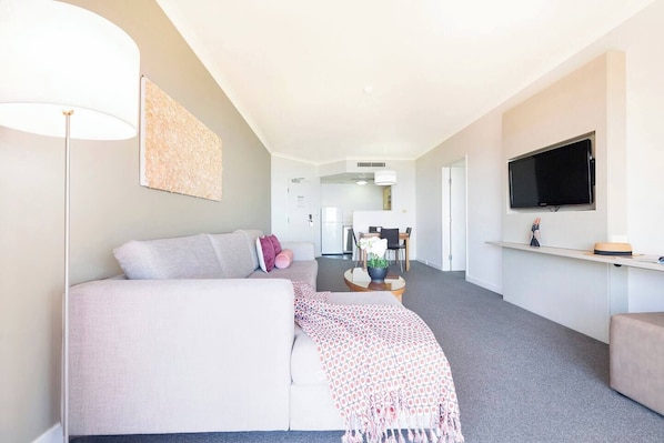 The spacious one-bedroom apartment has a dining area as well as a sun-soaked living room with a TV and Wi-Fi.