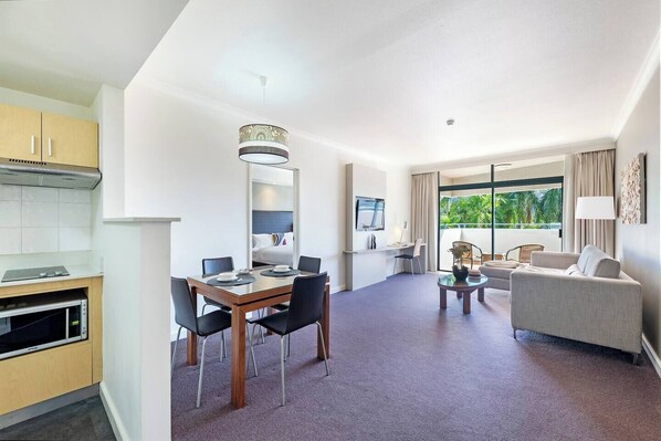A four-person dining table in the living area allows guests the space to come together for a shared meal. There are also abundant restaurants and eateries nearby.