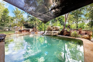 Experience rural serenity with a huge outdoor garden and private pool surrounded by towering emerald trees