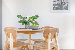 Guests can share meals together at the four-seater dining table.
