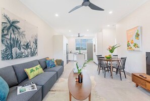 Kick back in the living area, thoughtfully styled with botanic flourishes and a central TV.

