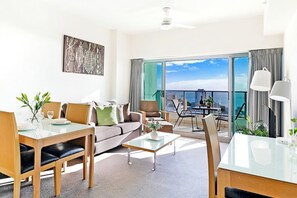 The open-plan living area flows to an undercover balcony creating a seamless transition with the outdoors.