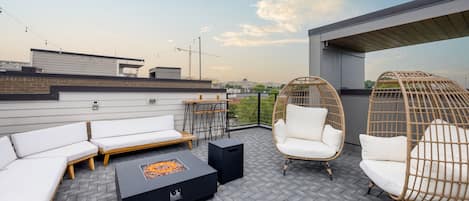 4th Floor: Rooftop Patio featuring outdoor dining and lounging with a firepit and neighborhood views.