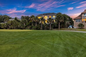 View of home at twilight from Ocean Winds Golf Course.  Quick access to the course with incredible views.