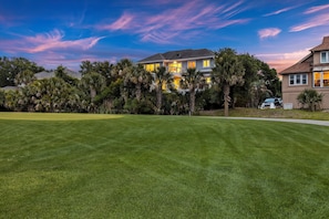 View of home at twilight from Ocean Winds Golf Course. Quick access to the course with incredible views.