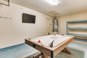 Unleash your competitive spirit and have a blast with our thrilling air hockey table, providing hours of fun in the garage game room.