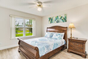 Unwind and recharge in this cozy bedroom featuring a queened-sized bed, the perfect sanctuary for restful nights and rejuvenating mornings.