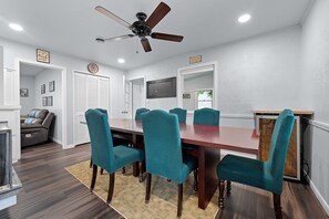 Dining room features seating for 8, ceiling fan, and a wine fridge! 