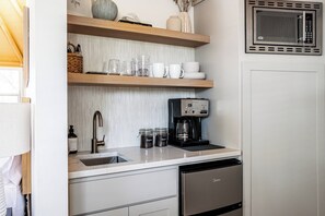 Kitchenette complete with mini fridge, microwave and local coffee grounds