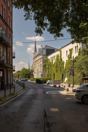 View of a charming street lined with greenery and classic architecture.

