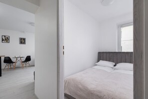 Cozy bedroom with a double bed and minimalistic decor for a relaxing atmosphere.

